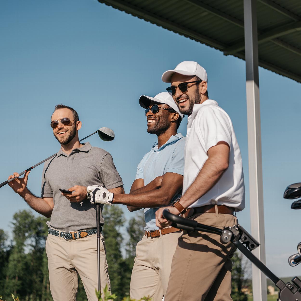 Group of three friends playing golf