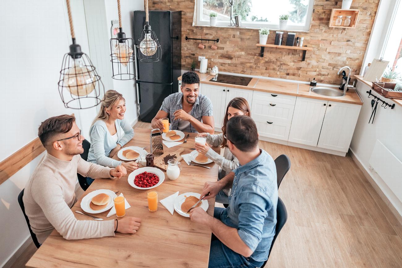 Group of friends eating breakfast at table